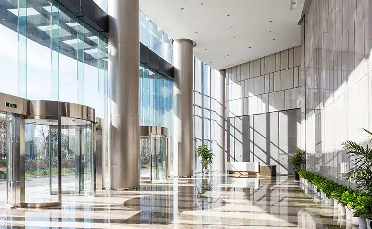 Services Landlord Rep A modern office lobby with glass and marble columns.